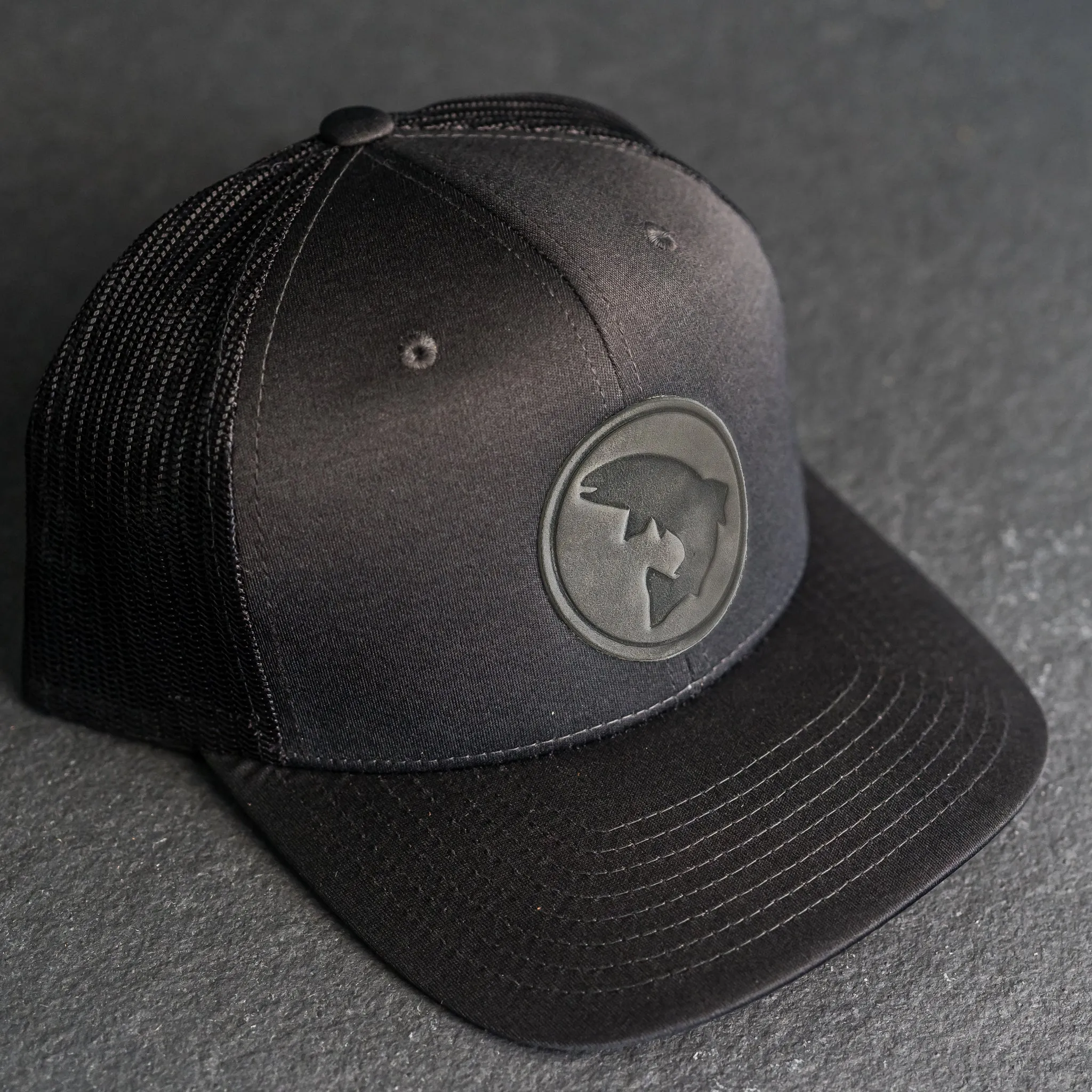 Leather Patch Performance Style Trucker Hat - Circle Patch - Fish Stamp